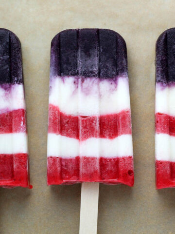 three layered popsicles with red, white, and blue layers