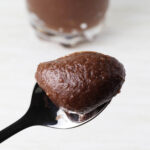 close up of a spoon of chocolate hazelnut frosting