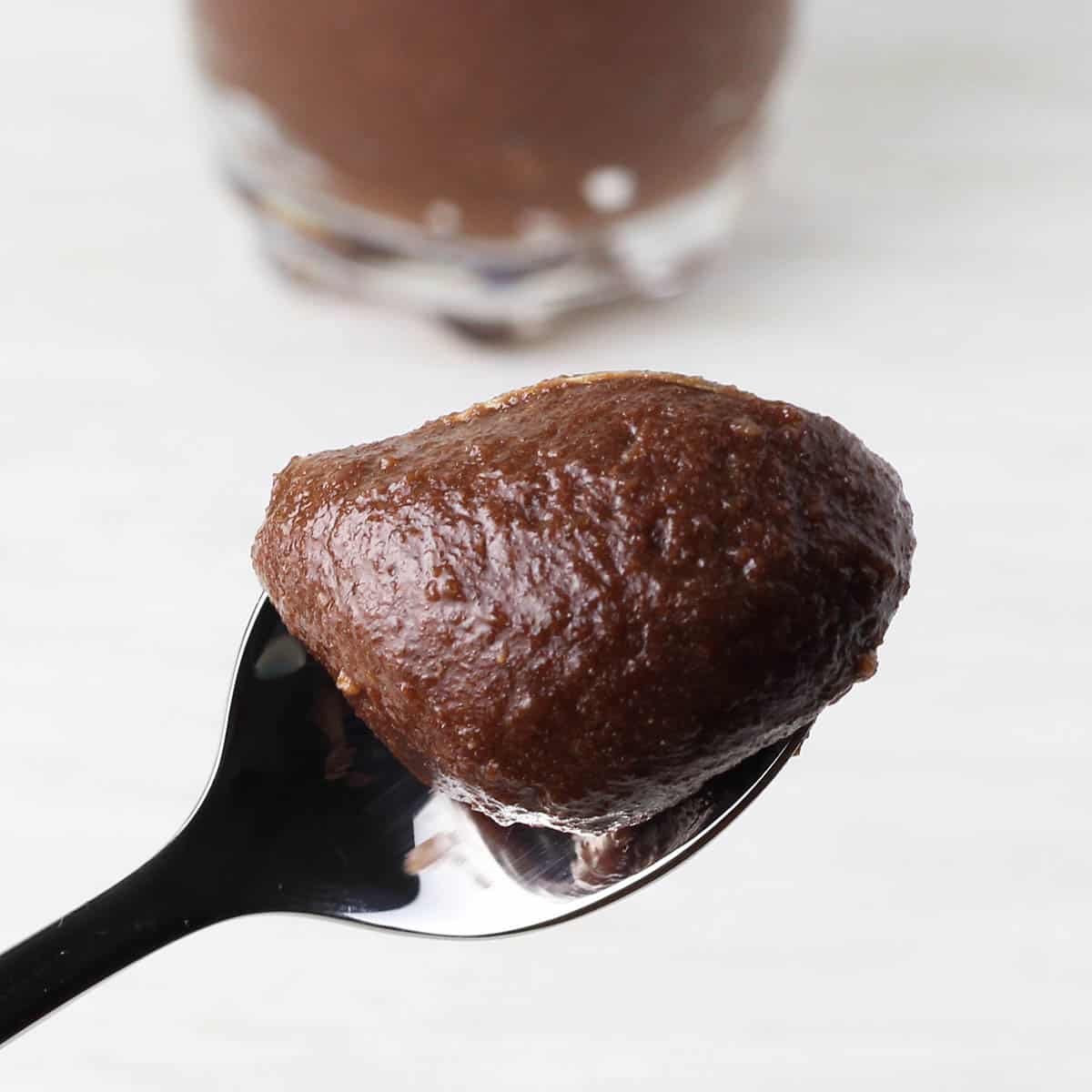 close up of chocolate hazelnut protein frosting on a spoon