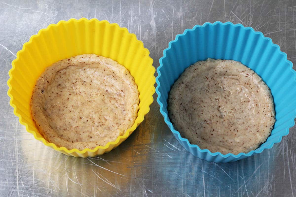 after being microwaved, two large silicone muffin cups with quest bar pressed into them as crust