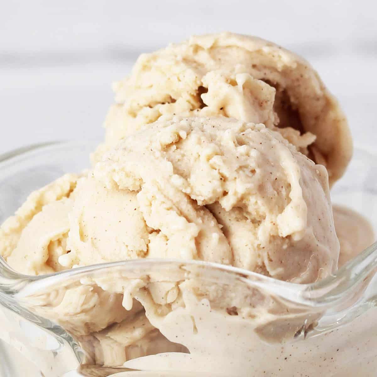 close of view of scoops of cinnamon protein frozen yogurt in a glass ice cream dish