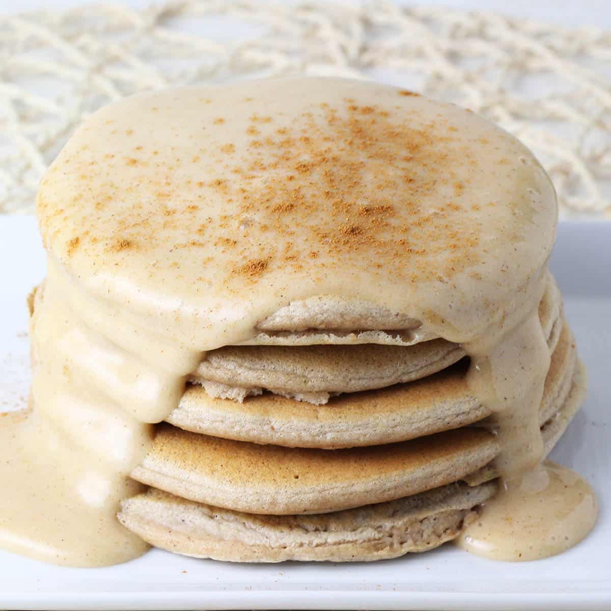 fluffy protein pancakes covered in protein icing and cinnamon sprinkled on top