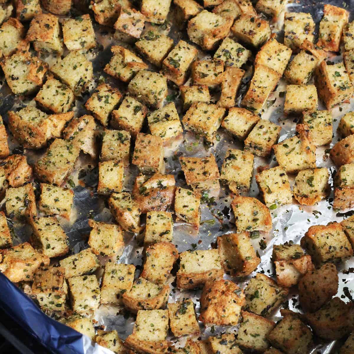 seasoned low carb croutons on a foil-lined pan