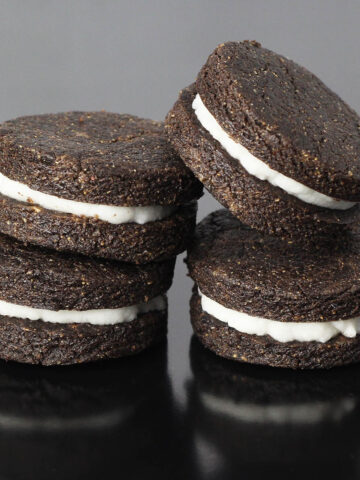 four oreo-inspired protein cookies on a black background