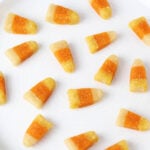 sixteen pieces of protein candy corn spread out on a white plate