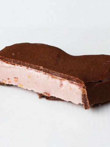 inside cut of a raspberry cream protein chocolate on a white plate