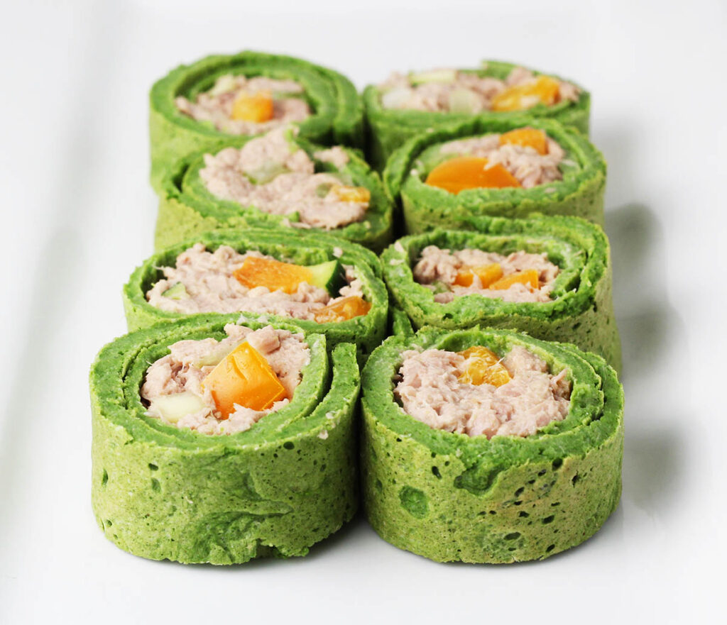 six pieces of sliced spinach wrap filled with tuna salad