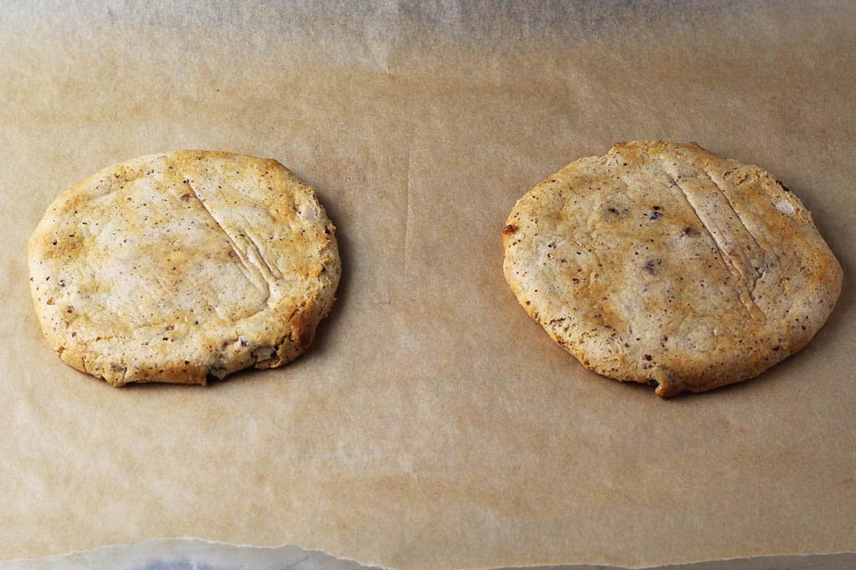 two large round cookies made by baking and shaping two halves of a vanilla almond quest bar