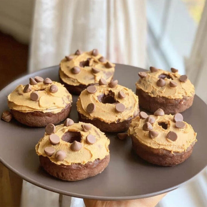 a plate full of donuts with peanut butter topping and chocolate chips