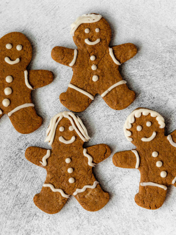 4 iced gingerbread protein cookies on a grey background