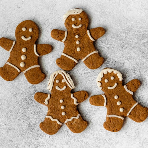 4 iced gingerbread protein cookies on a grey background
