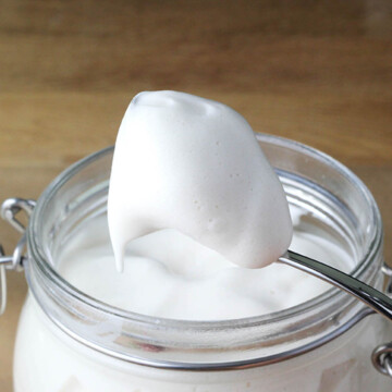 a jar full of protein marshmallow fluff with a spoon full coming out of the jar