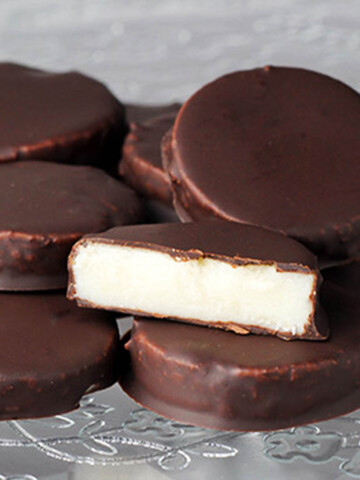 a pile of sugar free peppermint patties with one cut to show the inside