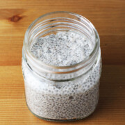 small mason jar of chia pudding on a wooden table