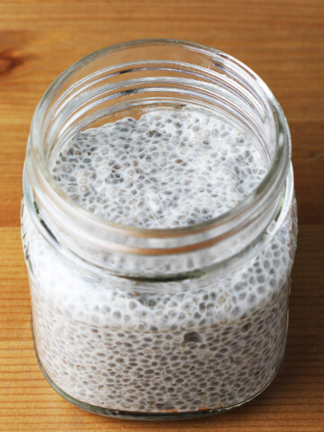 small mason jar of chia pudding on a wooden table