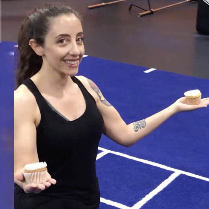 andrea at the gym holding cupcakes