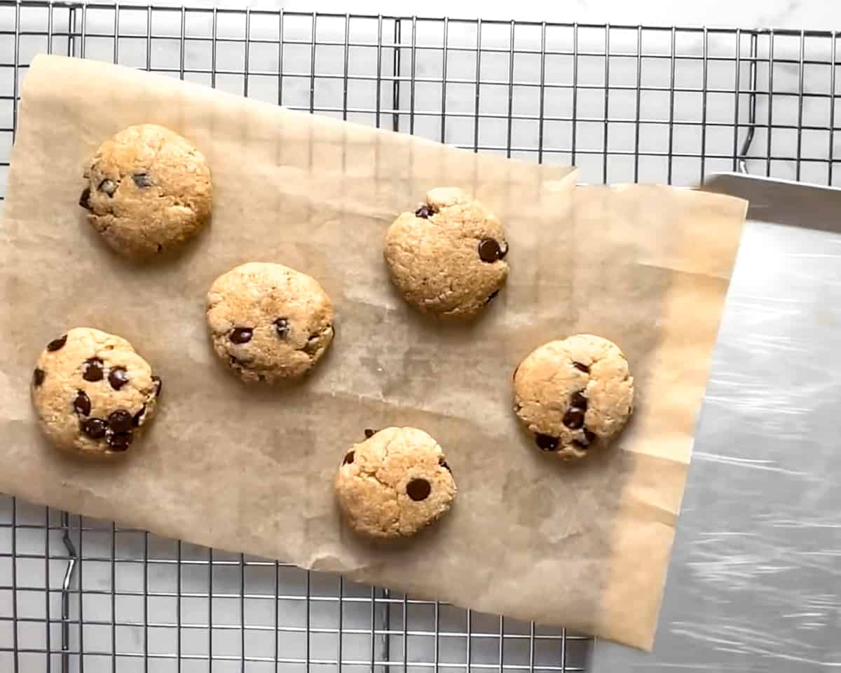 sliding parchment with cookies onto cooling rack