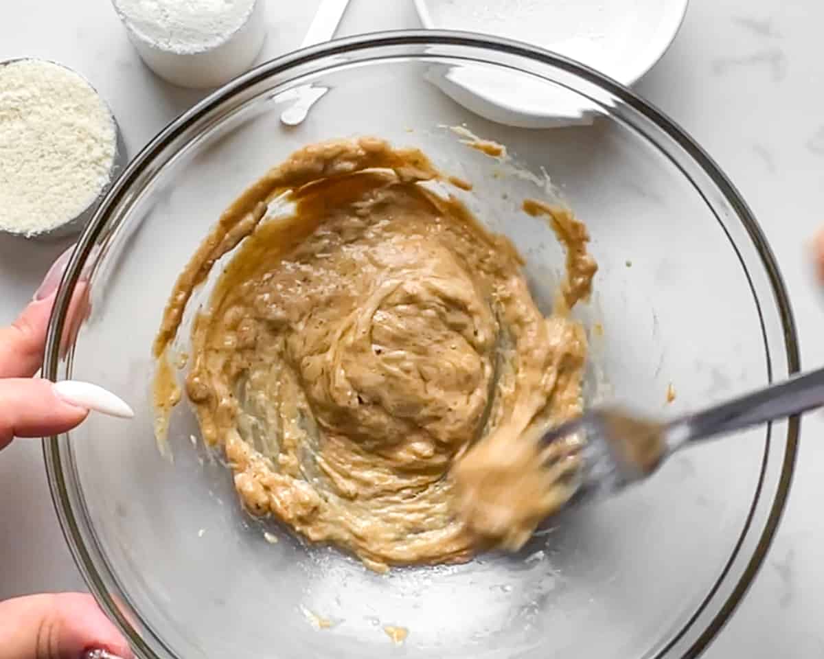 cashew butter and egg whites being mixed with a fork