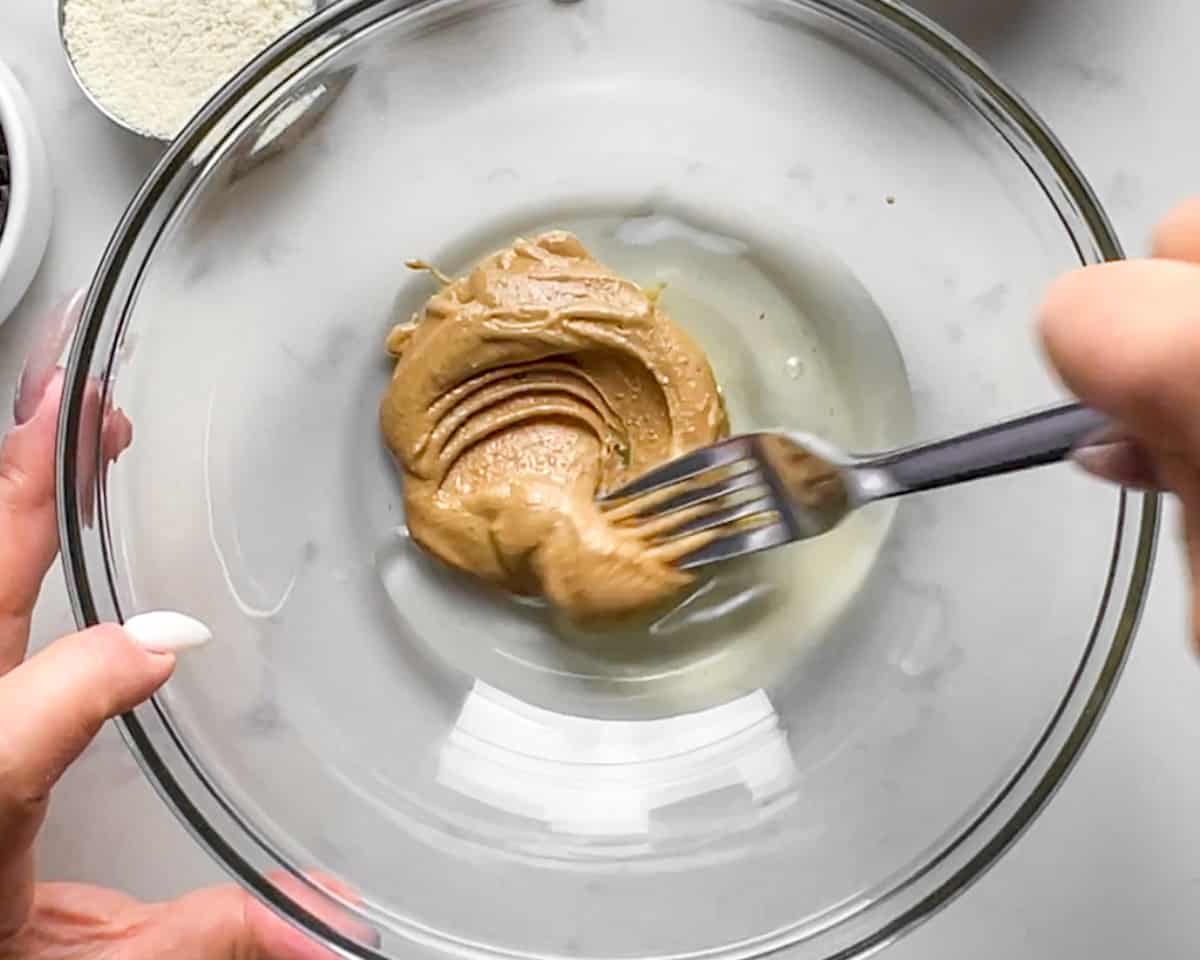 cashew butter and egg whites being mixed with a fork