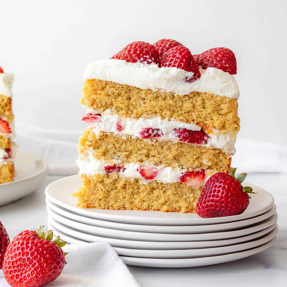 vanilla layer cake with strawberries and whipped cream