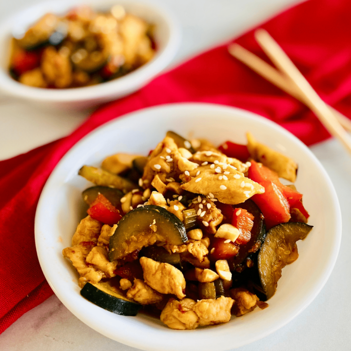 bowl of kung pao chicken with chopsticks