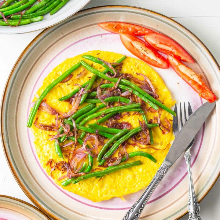 vegan omelette on a plate with fork and knife