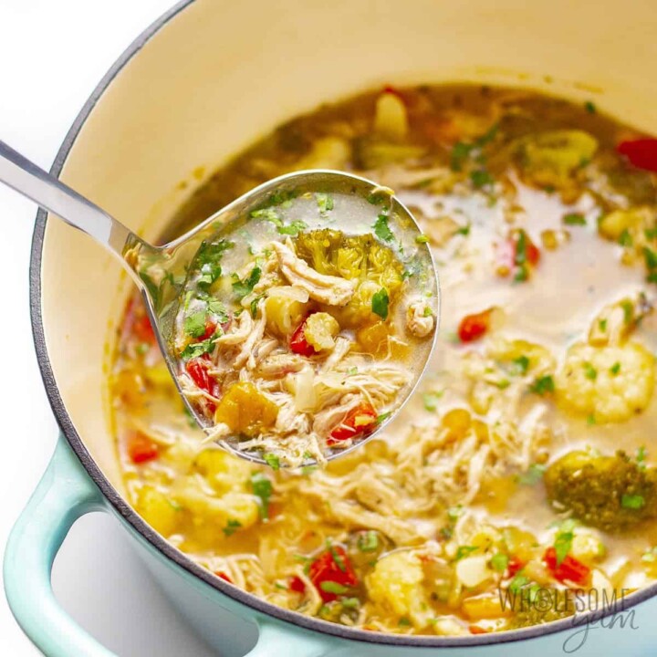 ladle of chicken soup being pulled from the pot