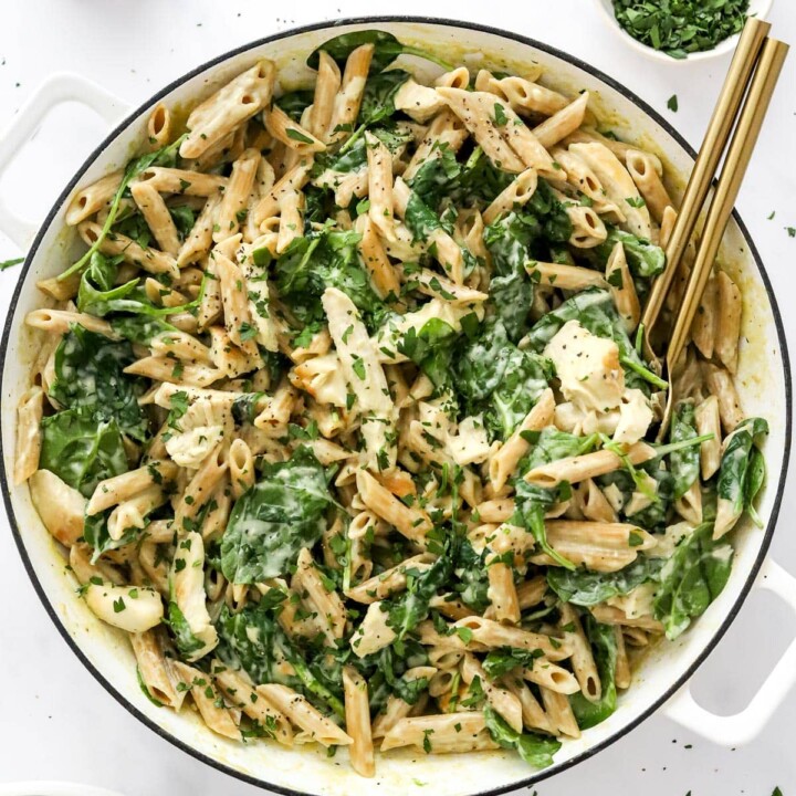 top view of a bowl with chicken and spinach pesto pasta