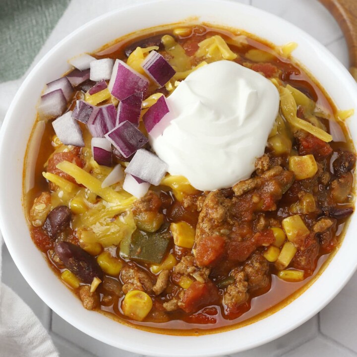 top view of a bowl of turkey chili topped with sour cream