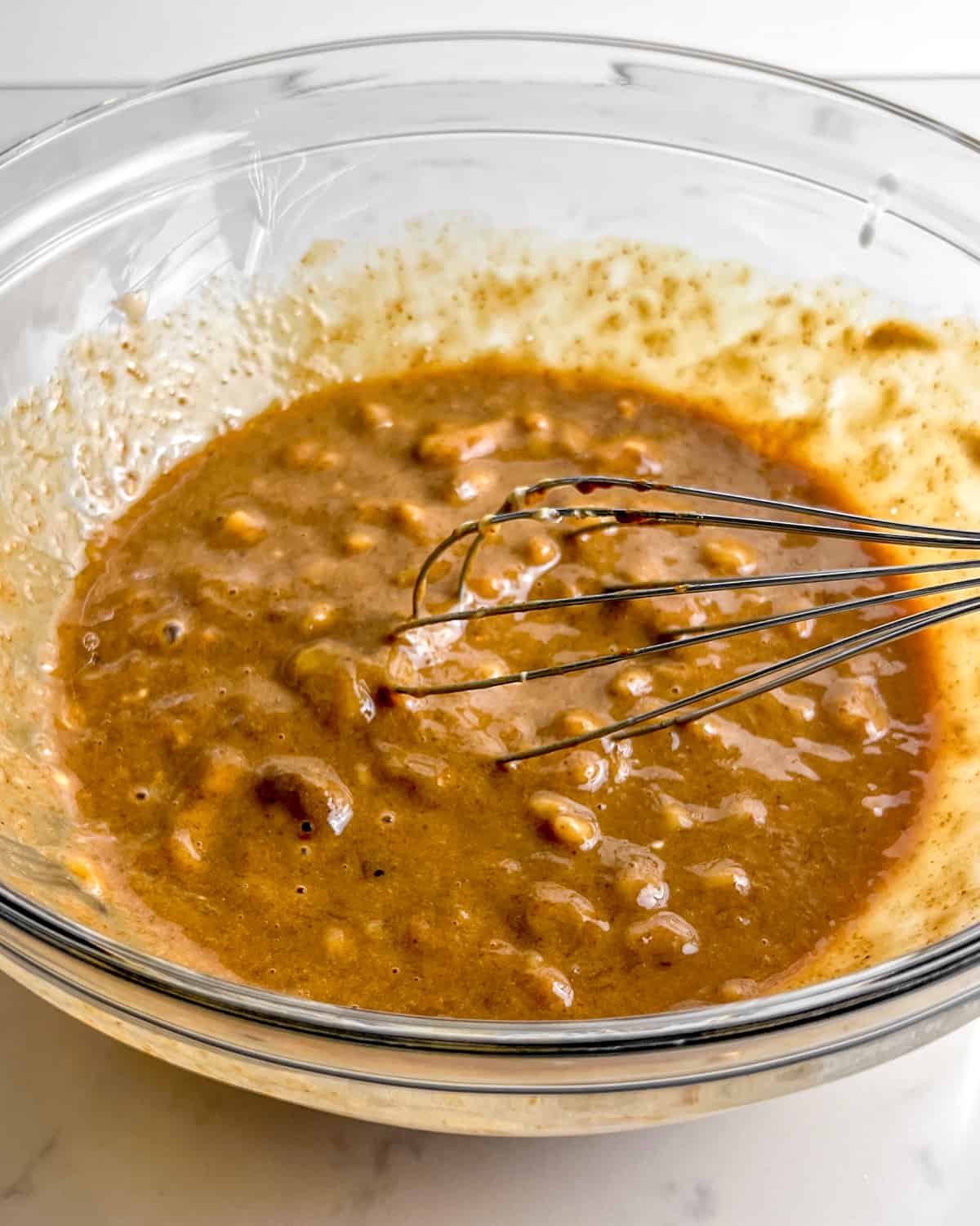 bowl of mashed bananas mixed with coconut sugar and Greek yogurt.