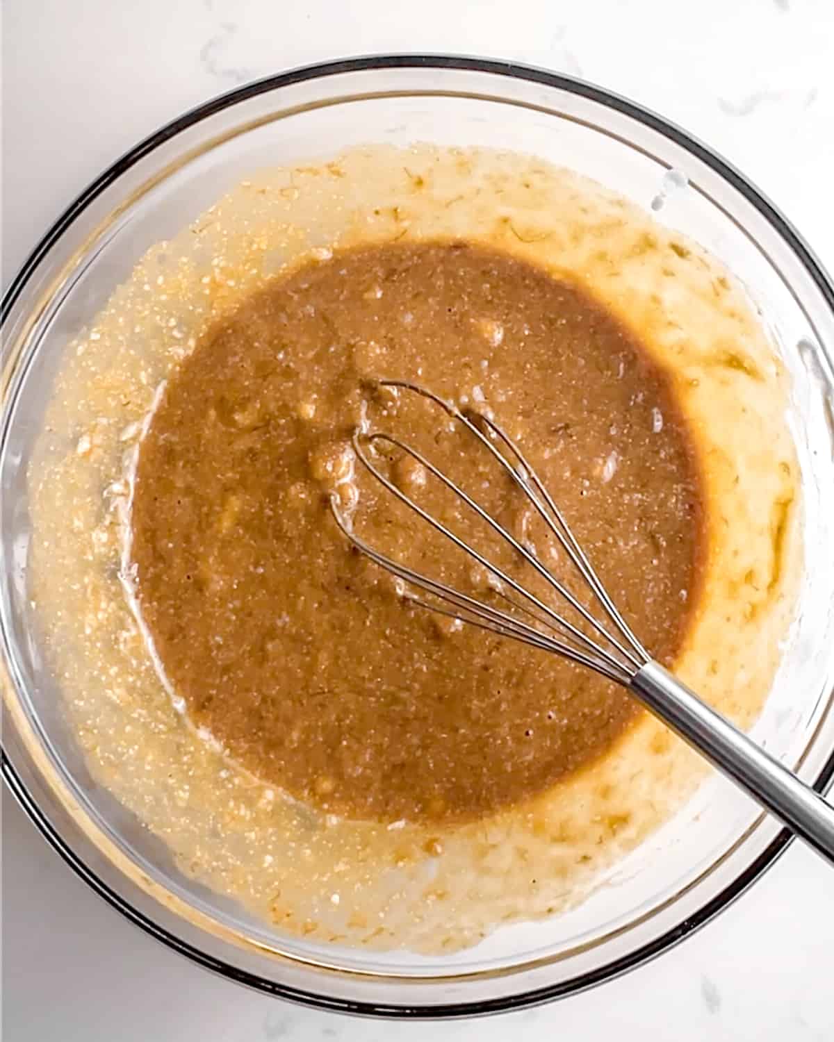 bowl of mixed wet ingredients for protein banana bread before the dry ingredients are added.