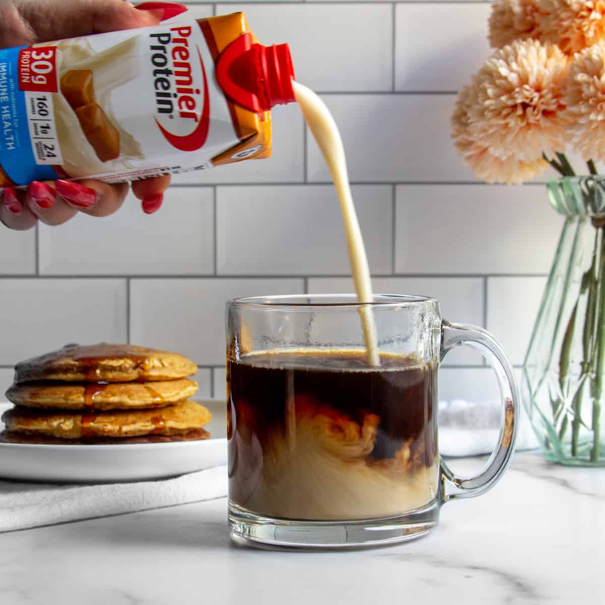 premier protein shake being poured into hot coffee