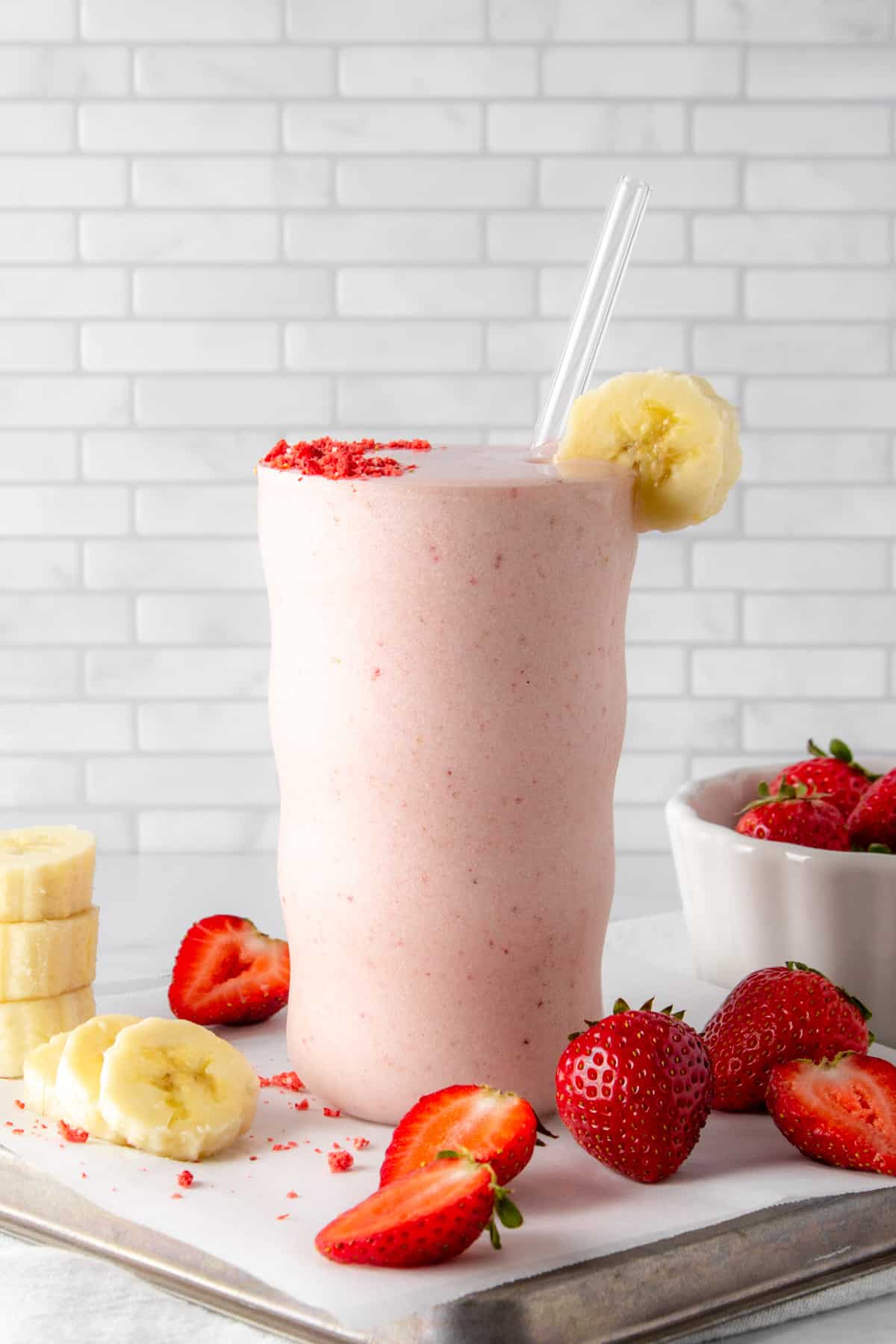strawberry banana protein shake with fresh strawberries and sliced banana