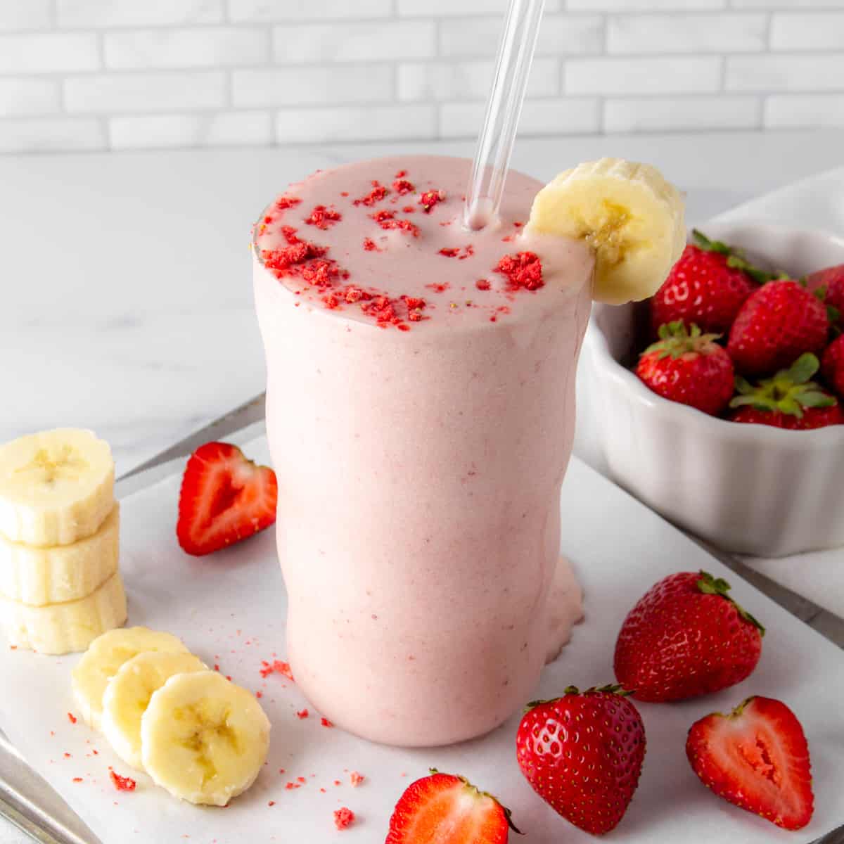 strawberry banana protein shake with fresh strawberries and sliced banana