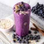 blueberry protein shake topped with blueberries.