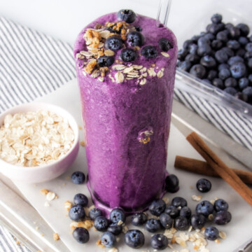 blueberry protein shake topped with blueberries.