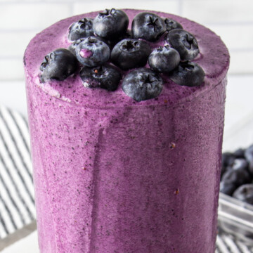blueberry protein shake topped with blueberries.