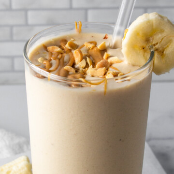 banana peanut butter shake in a glass.