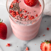 strawberry chia collagen smoothie with chia and dried strawberry on top.