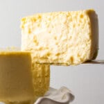 a slice of creamy protein cheesecake being lifted and pulled from the cheesecake.