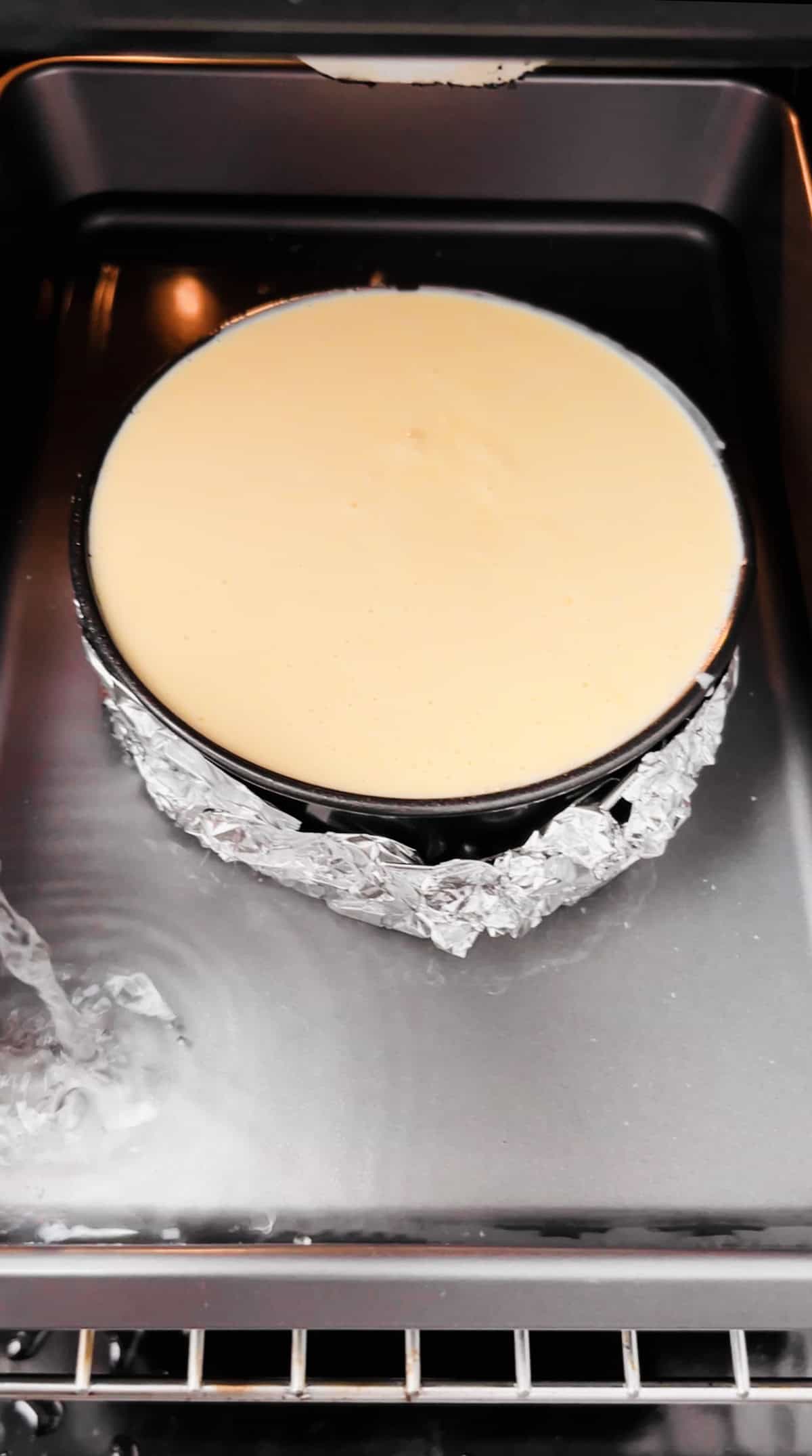 protein cheesecake in a water bath in the oven.