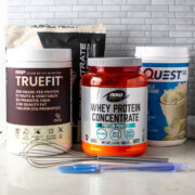 4 different protein powders with a whisk and spatula.