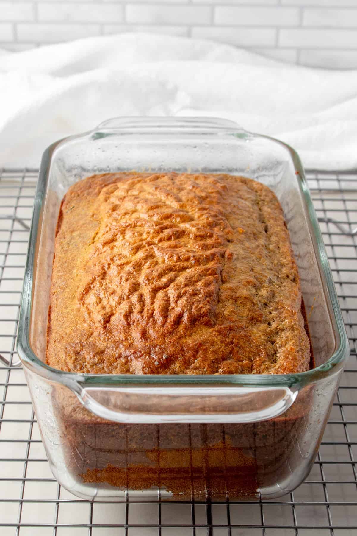 baked protein zucchini bread in a glass loaf pan.