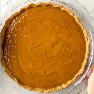 unbaked high protein pumpkin pie in a glass pie dish.
