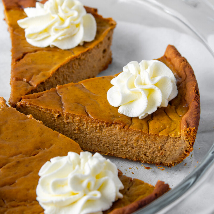 three slices of high protein pumpkin pie in the pie dish, with sugar free whipped cream on top.