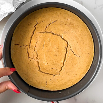 high protein pumpkin cheesecake in a springform pan after being baked.