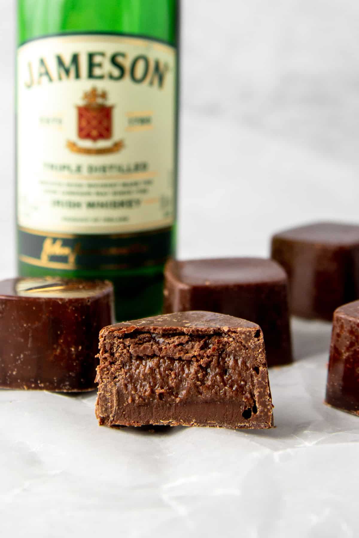 sugar free filled chocolates with whisky chocolate high protein filling, shown with a mini bottle of Jameson.