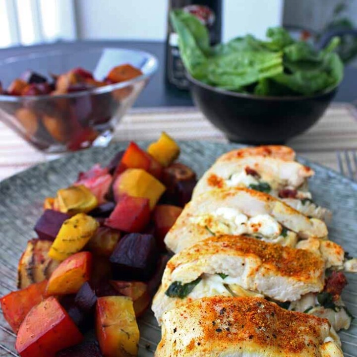 a piece of stuffed chicken breast next to roasted beets.