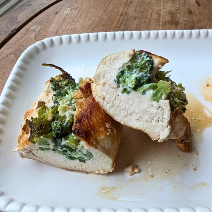 a piece of stuffed chicken breast cut into two pieces on a plate.
