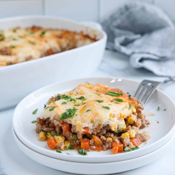 piece of turkey shepherds pie on a plate with a fork.